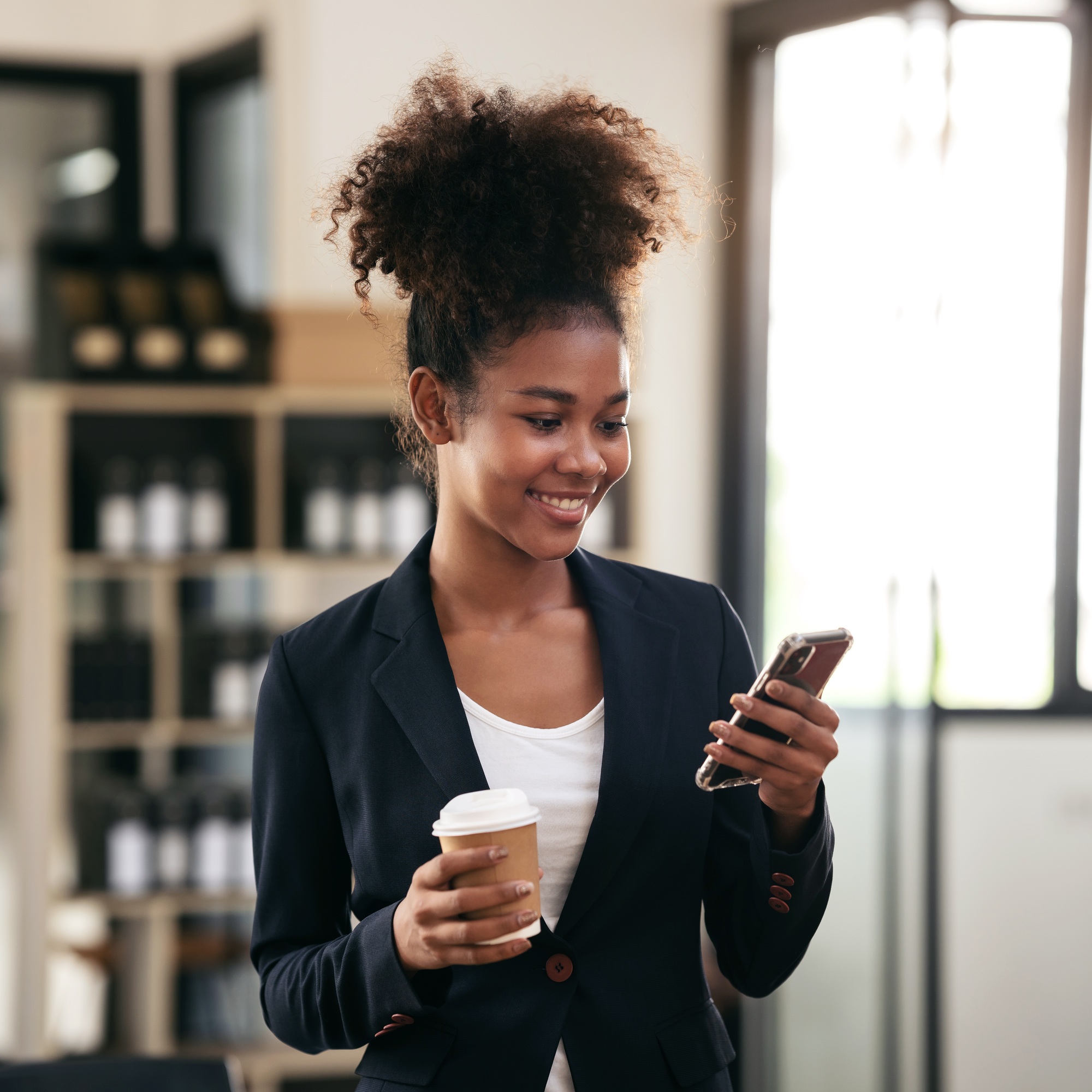 African american businesswoman drinking coffee and reading accounting information of new business